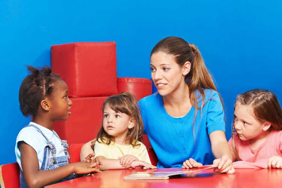 Adulto hablando con niñas sobre la tartamudez infantil